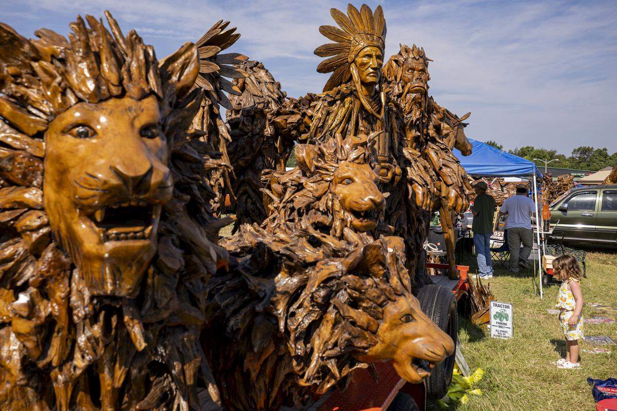 Statues stand tall during the annual 127 Yard Sale on Friday, Aug. 8, 2025, at  in Lawrenceburg, Ky.