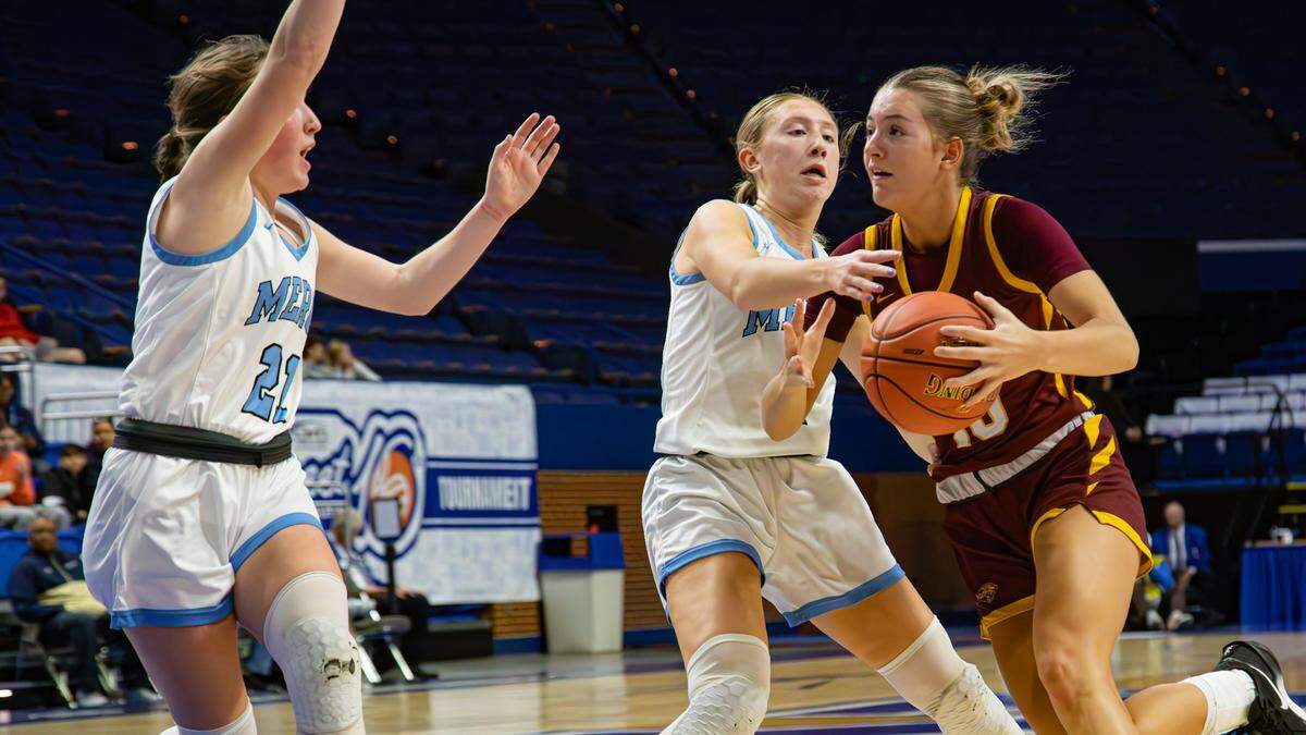 Cooper’s Haylee Noel (10) takes on a pair of Mercy Academy defenders during her team’s 70-45 Sweet 16 win Thursday. Noel scored a game-high 24 points and added 11 rebounds and five assists.