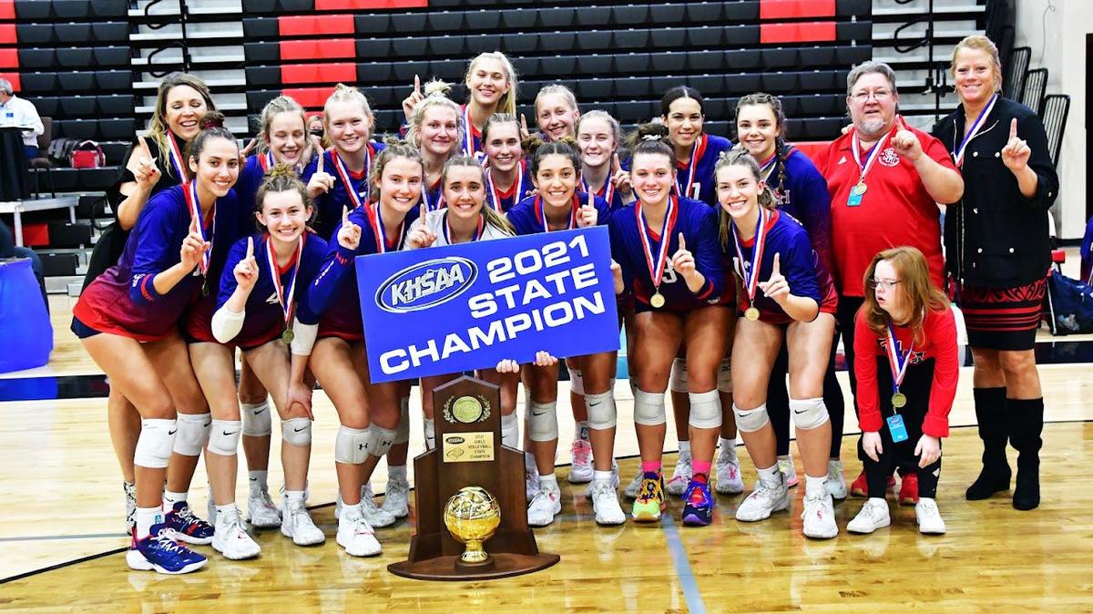 St. Henry players and coaches, led by head coach Maureen Kaiser, posed with their 2021 KHSAA State Volleyball Championship trophy Saturday after the Crusaders defeated Mercy 3-0 in the finals.