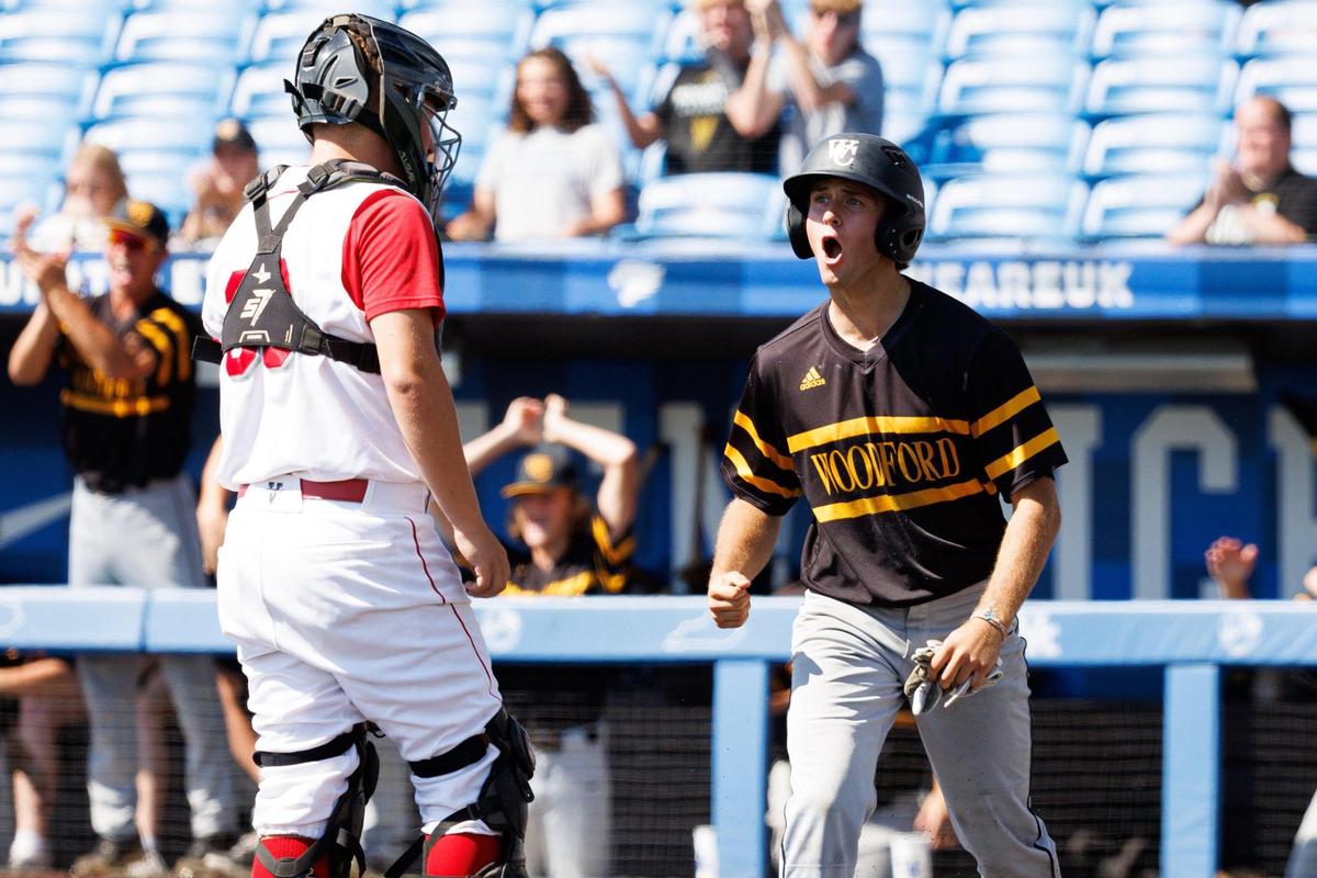 Woodford County’s Brandon Rankin, right, celebrates scoring a run during the Yellow Jackets’ 10-3 quarterfinal victory over Boyd County on Saturday.