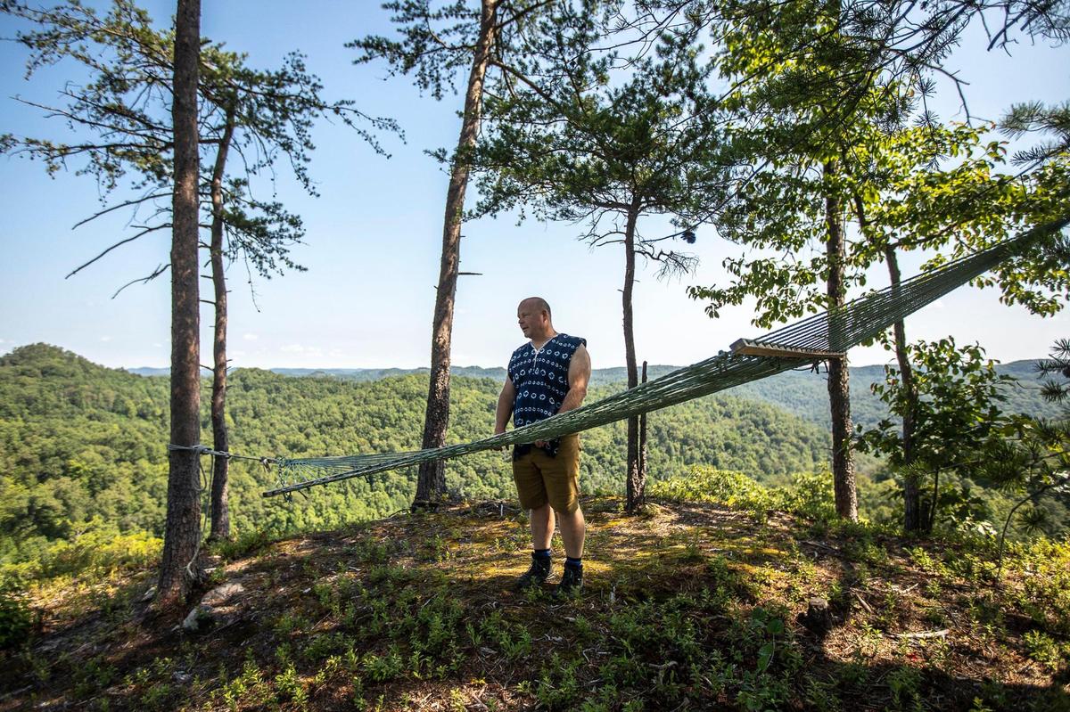 Ian Teal stands on an overlook on property he owns near the Slade exit off the Mountain Parkway, close to the Natural Bridge State Park, in Powell County, Ky., on Friday, Aug. 7, 2020. The Red River Economic Development LLC has an option on Teal’s property to develop a “destination resort.”