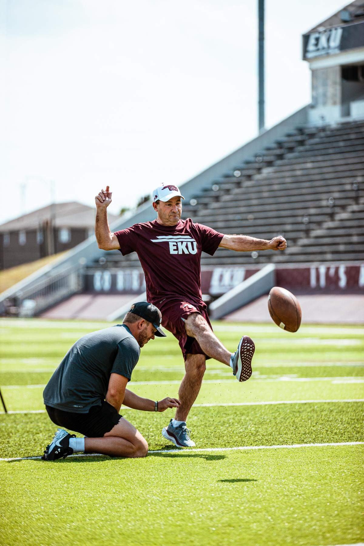 EKU AD Kyle Moats (kicking) hopes that the changing structure of big-time college sports does not put an end to football games between FCS schools such as Eastern Kentucky and power conference teams. “Our kids love playing in those games,” Moats says.