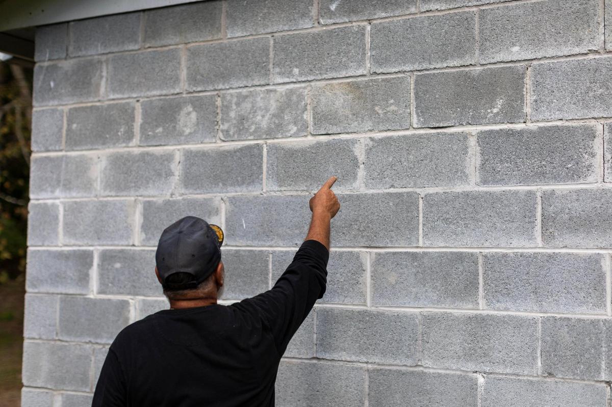 Harold “Tommy” Saylor points out cracks in the walls of his shed he claims has been caused by a Blackjewel strip-mine across from his property in Wallins Creek, Harlan County, Ky., Friday, October 2, 2020. The foundations of Saylor his neighbors houses and sheds have been damaged from the blasting at the mine that traveled up the holler.
