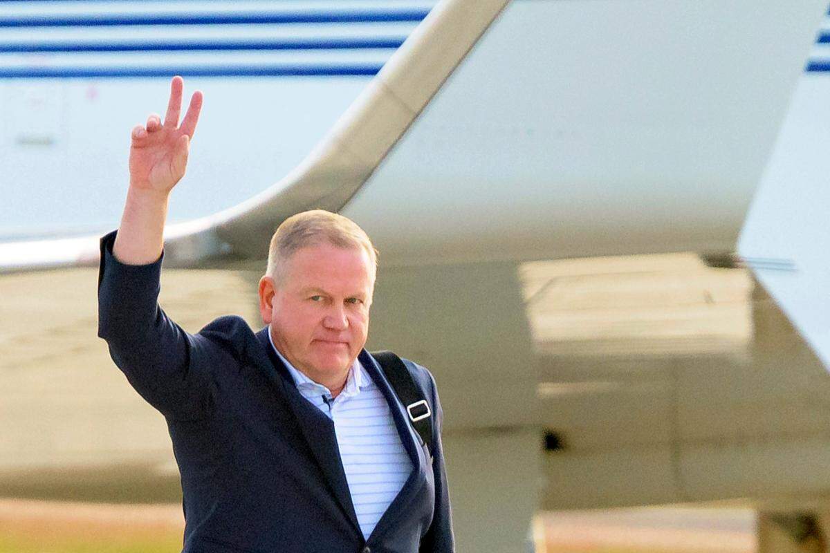 New LSU football coach Brian Kelly gestures to fans after his arrival at Baton Rouge (La.) Metropolitan Airport last week. Kelly reportedly agreed to a 10-year contract with LSU worth $95 million plus incentives.