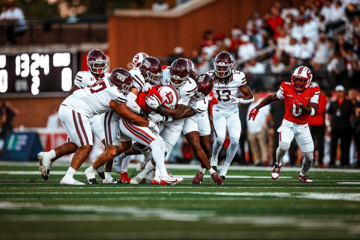 Members of the Eastern Kentucky University football team tackle a Western Kentucky ball carrier during the Battle of the Bluegrass between EKU and WKU at Houchens Industries–L. T. Smith Stadium in Bowling Green, Ky., on Saturday, Sept. 7, 2024.