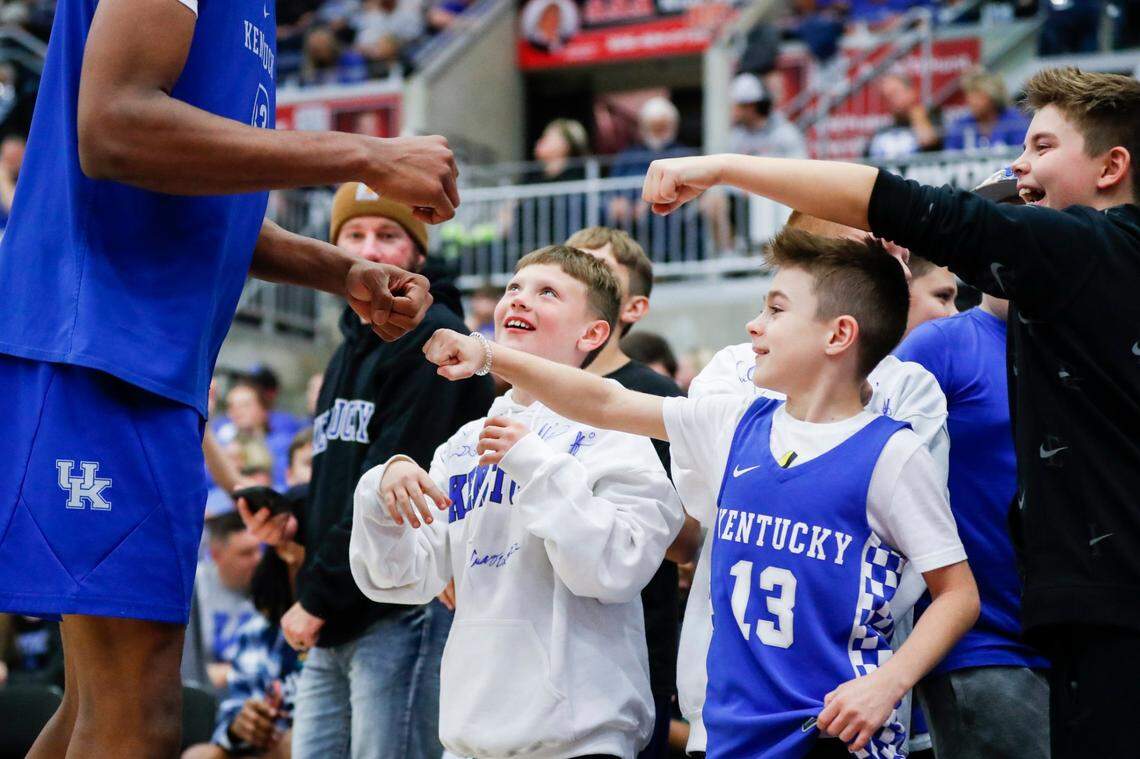 Kentucky’s Ugonna Onyenso, left, fist bumps young fans during the Blue-White Game at Appalachian Wireless Arena in Pikeville on Saturday.
