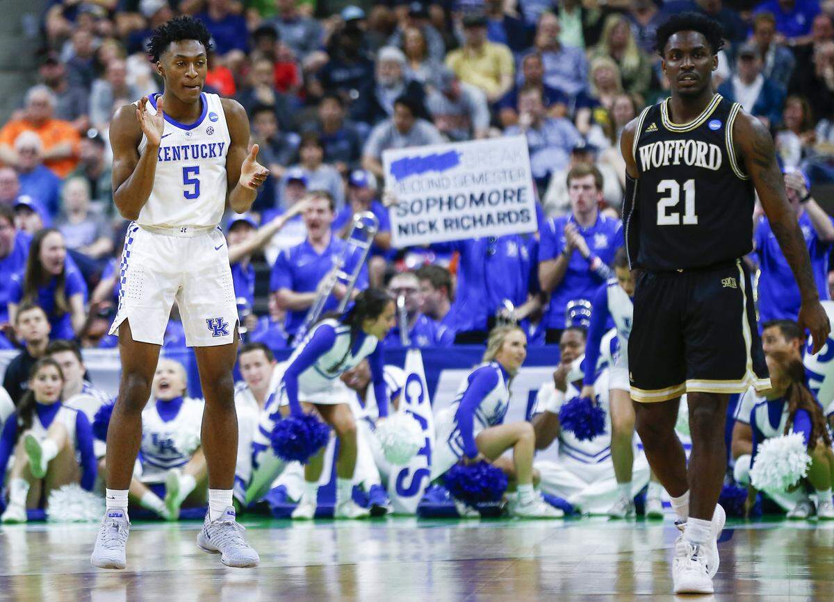 Kentucky’s Immanuel Quickley (5) celebrated near Wofford’s Tray Hollowell during Saturday’s game. Hollowell, a Kentuckian, had one rebound and one steal for the Terriers.