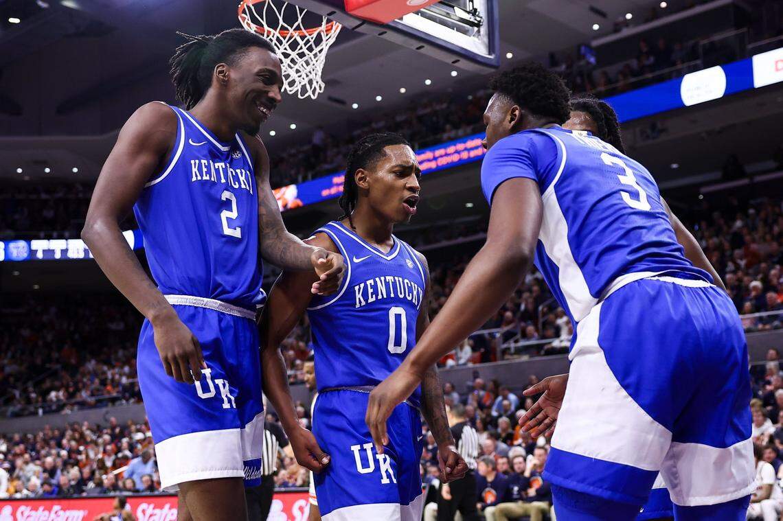 Kentucky’s Aaron Bradshaw, left, Rob Dillingham and Adou Thiero celebrate after a play in Saturday’s game at Auburn.