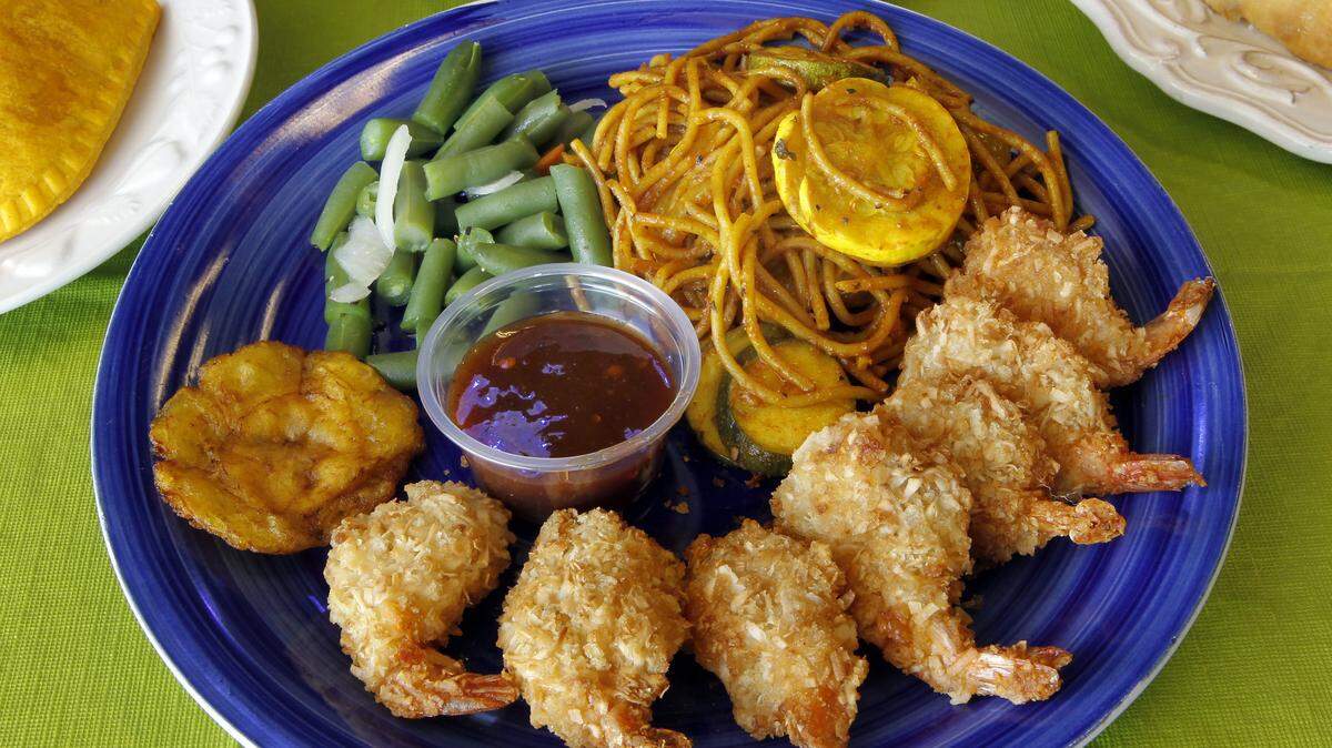 Rasta pasta accompanies coconut shrimp, fried plantain and the vegetable of the day.