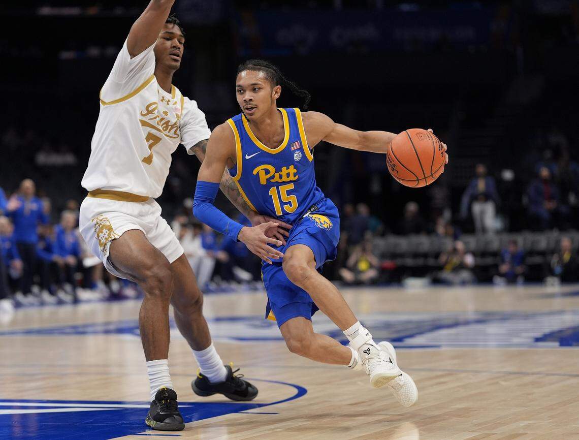Mar 11, 2025; Charlotte, NC, USA; Pittsburgh Panthers guard Jaland Lowe (15) drives to the basket against Notre Dame Fighting Irish forward Tae Davis (7) during the first half at Spectrum Center. Mandatory Credit: Jim Dedmon-Imagn Images