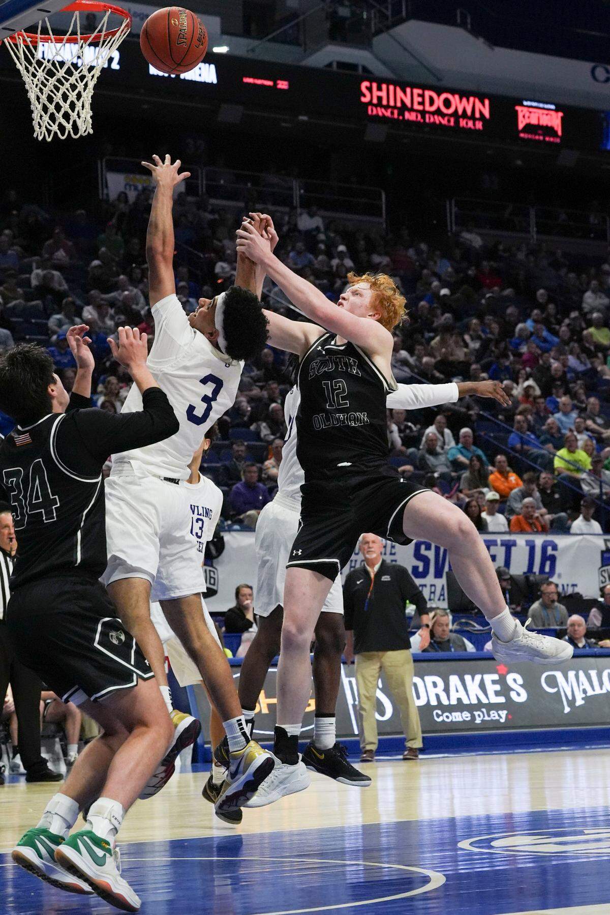 Bowling Green senior Braylon Banks (3) tries to grab the rebound between South Oldham seniors Brooks Bee, left, and William Burnside during the Boys’ Sweet 16 semifinals at Rupp Arena on Saturday.