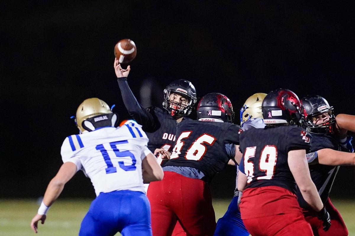 Dunbar’s Jake Smith (18) completed 12 of 20 pass attempts for 210 yards and two touchdowns.