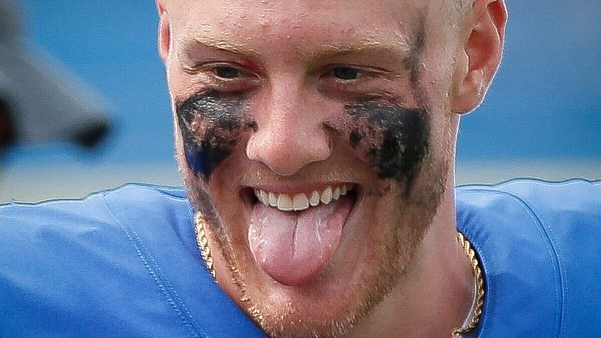 Kentucky Wildcats quarterback Will Levis (7) reaches for a piece of gum after a game against the Louisiana Monroe Warhawks at Kroger Field in Lexington, Ky., Saturday, Sept. 4, 2021.