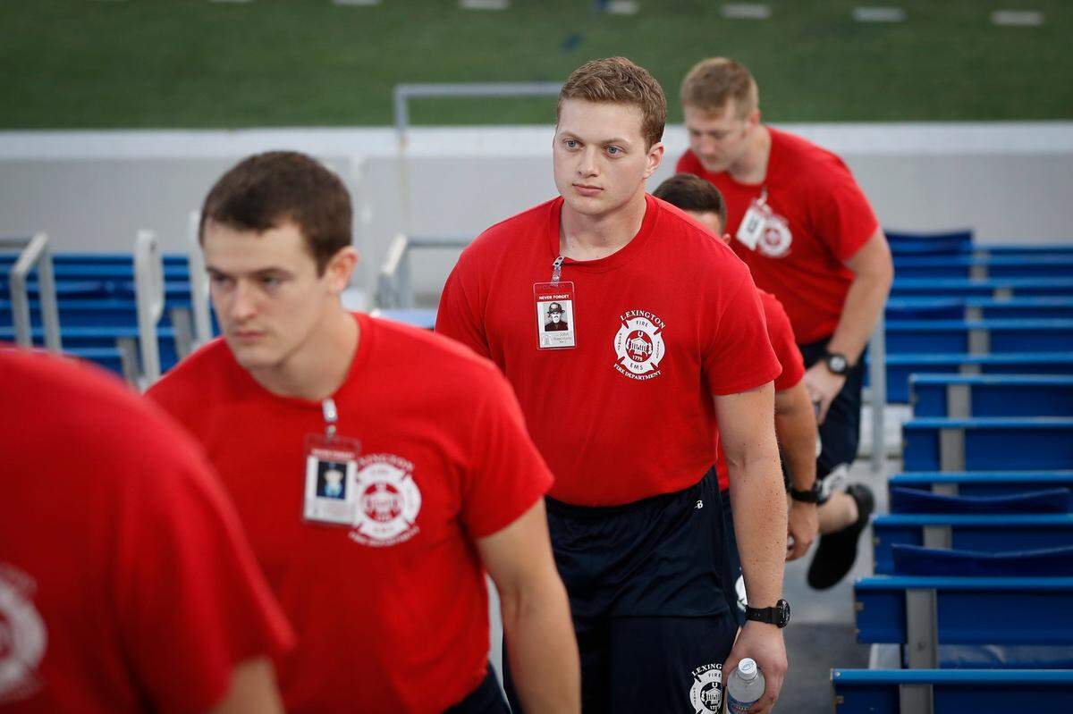 Lexington recruit firefighter Alex Wilbur, of Richmond, center, participated in a 9-11 Memorial Stair Climb at Kroger Field in Lexington Thursday. Attendees were encouraged to climb the equivalent of 110 flights of stairs to honor the first responders who were killed in the terror attack on the World Trade Center.