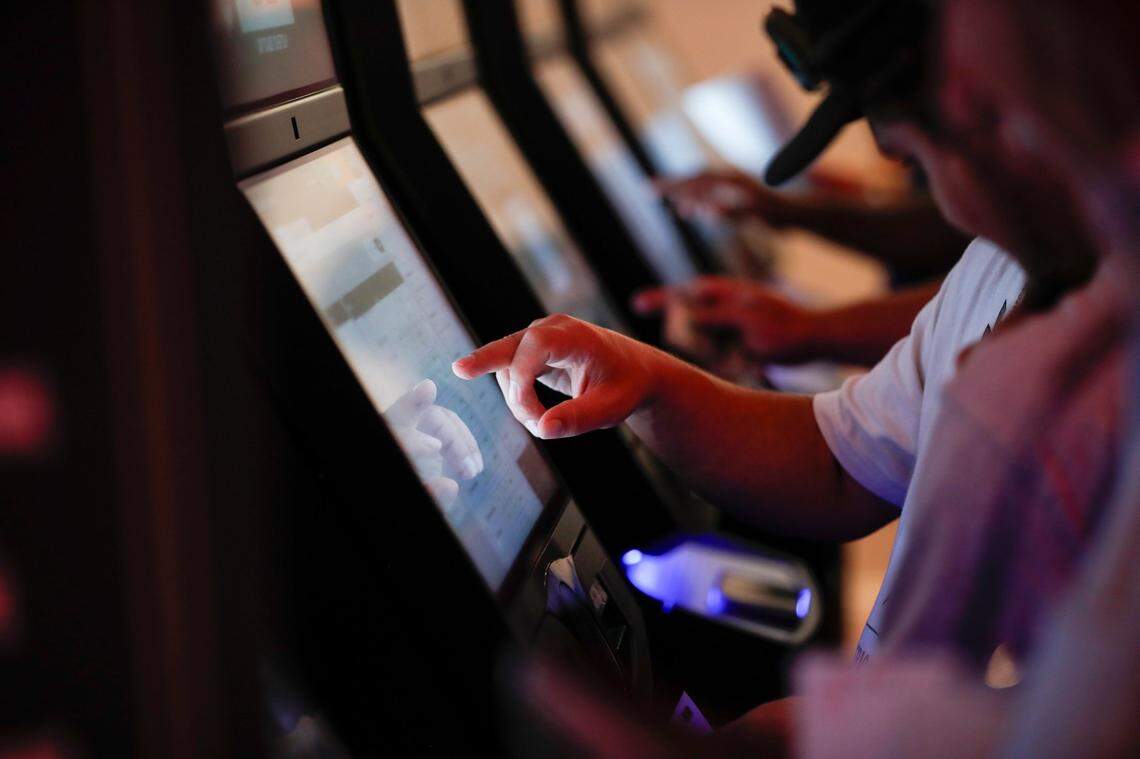Patrons place bets after a press conference where Gov. Andy Beshear announces the opening of a Caesars Sportsbook and made comments on the first day of sports betting legalization in the Commonwealth at Red Mile in Lexington, Ky, Thursday, September 7, 2023.