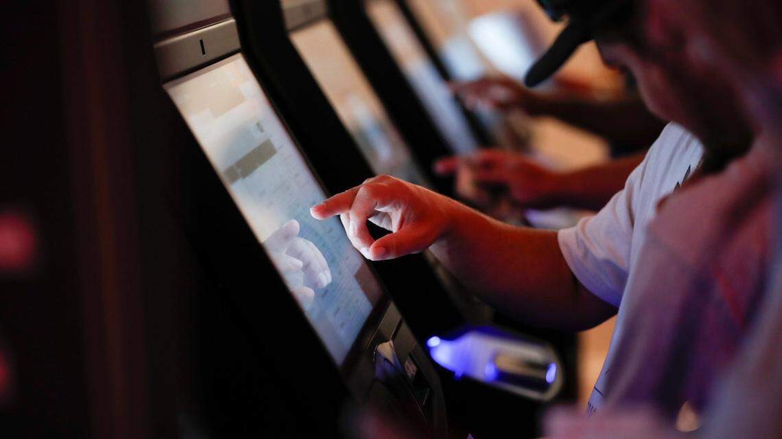Patrons place bets after a press conference where Gov. Andy Beshear announces the opening of a Caesars Sportsbook and made comments on the first day of sports betting legalization in the Commonwealth at Red Mile in Lexington, Ky, Thursday, September 7, 2023.