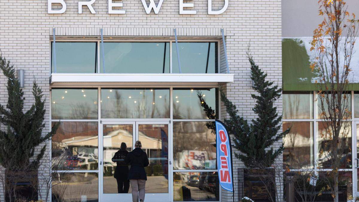 Patrons come and go from Brewed in Lexington, Ky., Wednesday, December 2, 2020. The coffee shop and bar has been operating in defiance of Gov. Andy Beshear’s mandates to close to in-person dining due to the coronavirus.