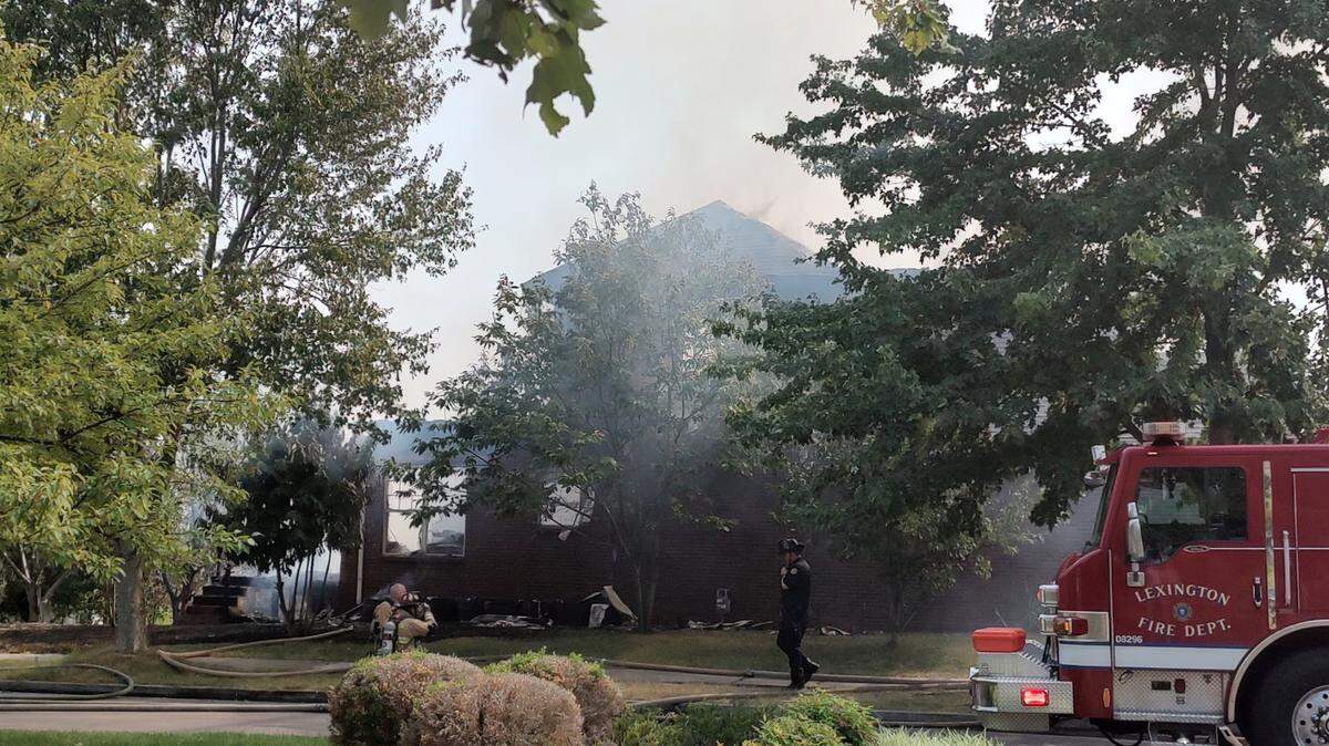 Firefighters battled a structure fire at a home on Jane Briggs Avenue in Lexington, Ky., Saturday afternoon. A fire department spokesman later said part of the home collapsed.