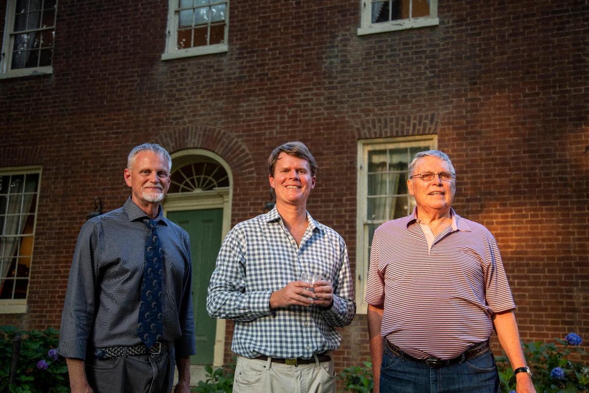 Bill Samuels Jr. (right), Rob Samuels (center) and Jeff James (left) poses for a photo in front of the 200-year-old Samuels family home after an open house outside Bardstown, Ky., Tuesday, July 27, 2021.