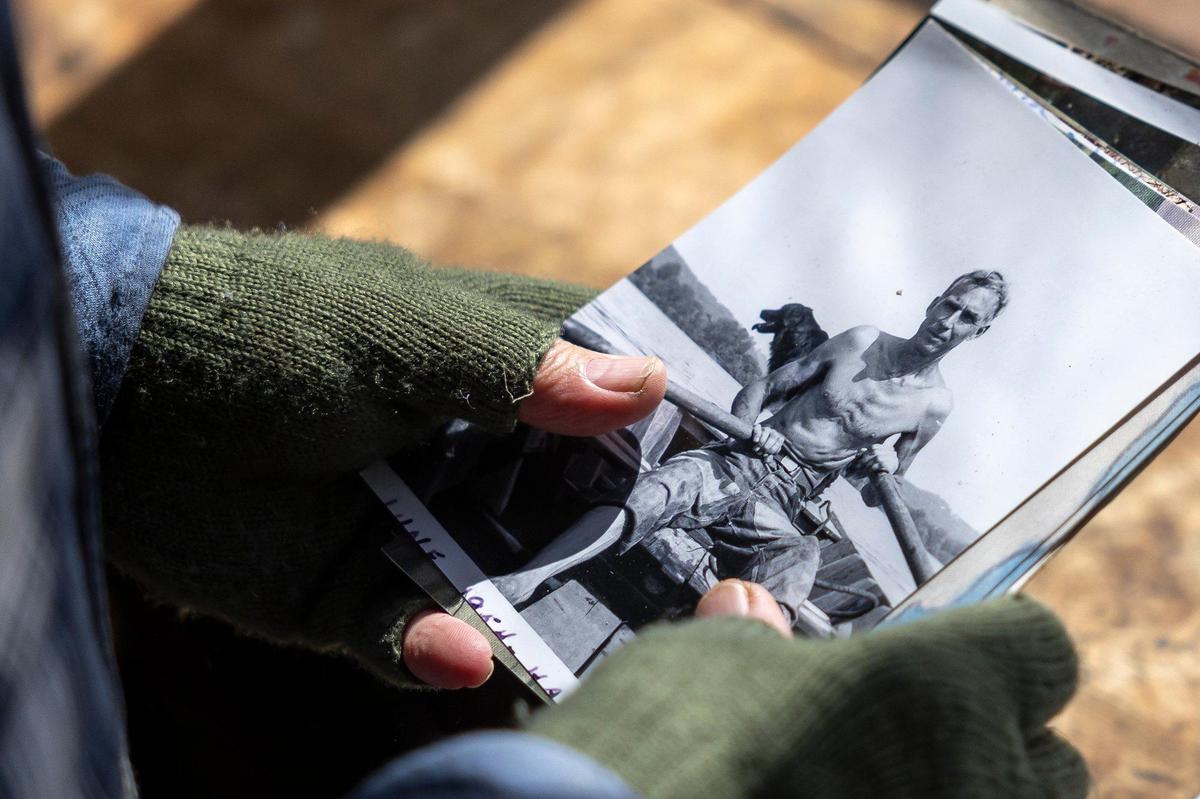 Joe Wolek, a founding member of Payne Hollow on the Ohio, holds a photograph of Harlan Hubbard at Payne Hollow in Trimble County, Ky., on Thursday, March 6, 2025. Hubbard lived with his wife, Anna, off their land in a very remote and sustainable way for about 40 years at Payne Hollow.