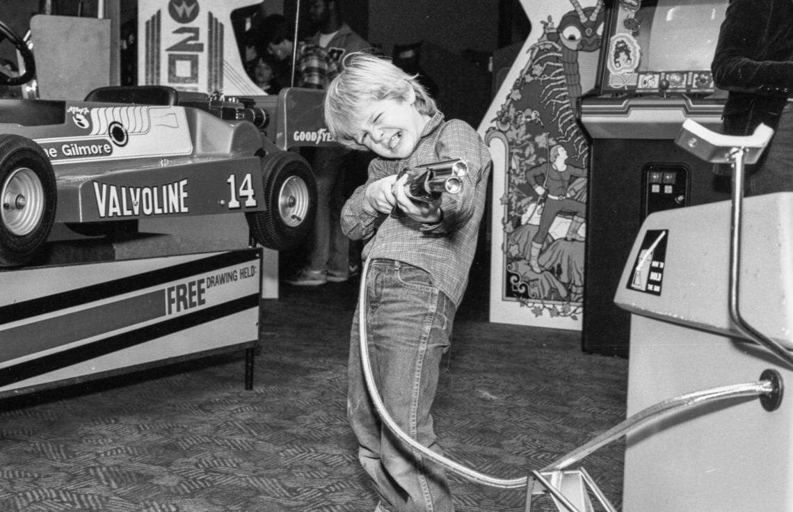 A kid plays with a video game gun in the arcade at ShowBiz Pizza Place, Wednesday, Jan. 4, 1984 at Woodhill Circle Plaza in Lexington, Ky. When it opened in Dec. 1983, the family pizza and entertainment restaurant advertised it had the hottest games like M.A.C.H. 3 and Dragon's Lair.  In 1991 the restaurant was rebranded Chuck E. Cheese and in 2025 it closed. Photo by Christy Porter, Herald-Leader file photo