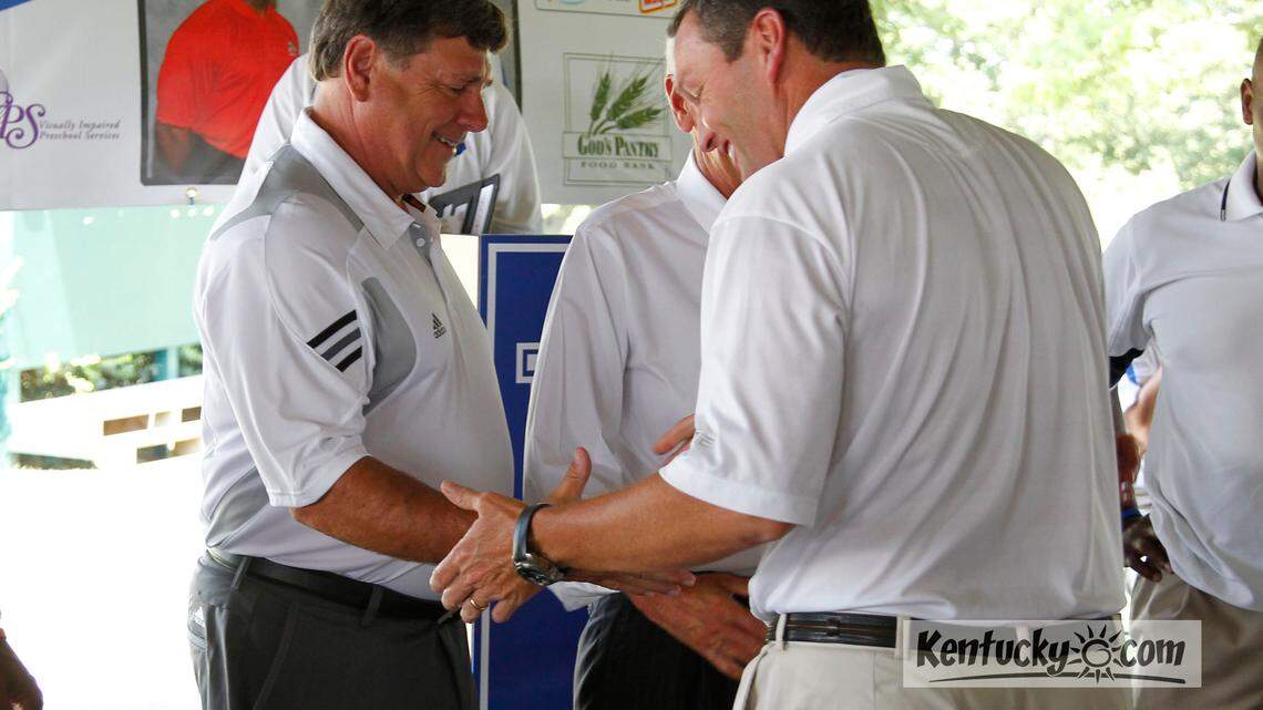 UK  Athletic Director Mitch Barnhart, greeted UofL Athletic Director Tom Jurich at the  annual luncheon to promote the Governor's Cup football game between the Cats and Cards  photographed  on Thursday July 25, 2011 in Lexington, Ky.  Photo by Mark Cornelison | Staff
