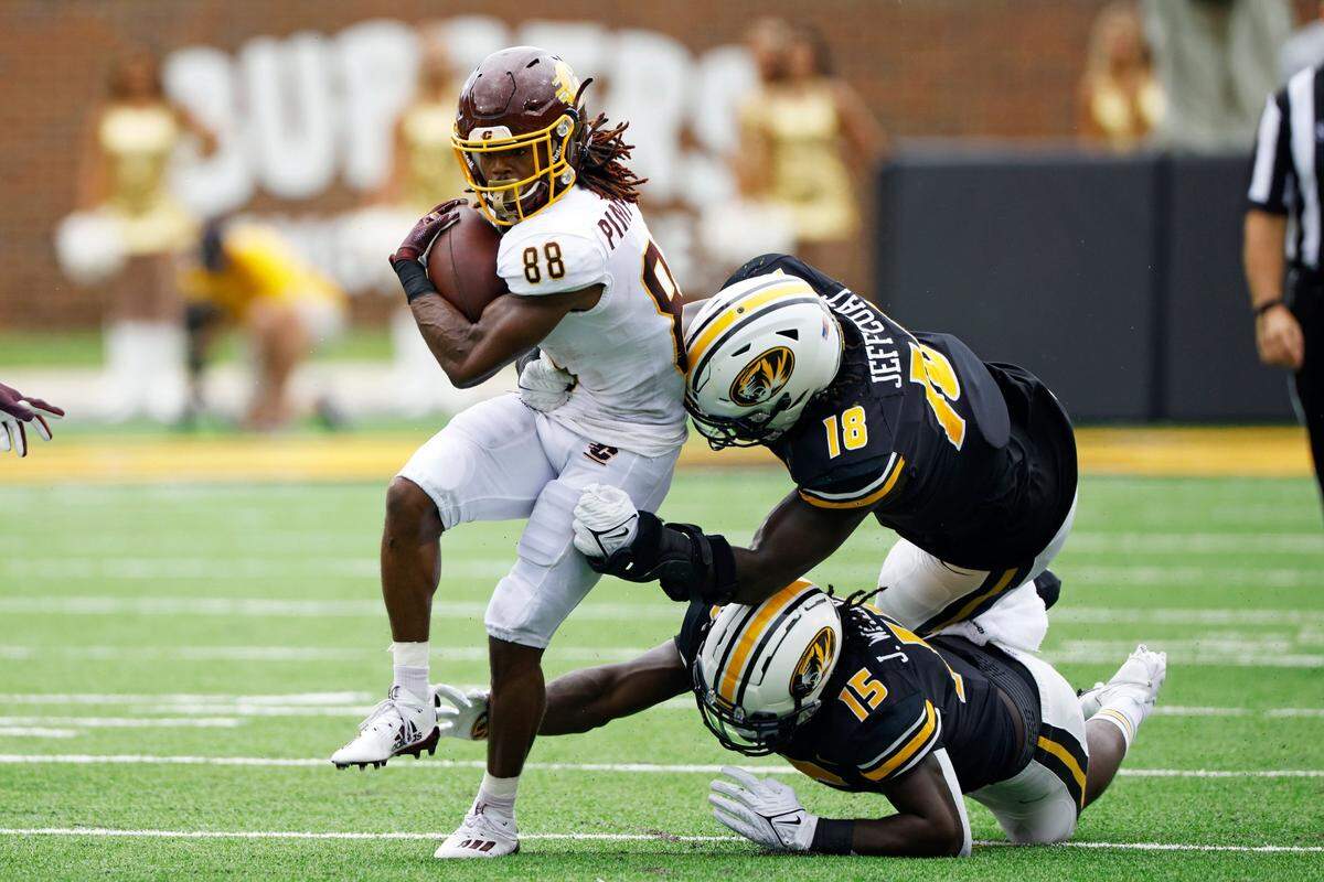 Central Michigan wide receiver Kalil Pimpleton (88) attempts to get past Missouri defensive linemen Johnny Walker Jr. (15) and Trajan Jeffcoat (18) during Mizzou’s 34-24 victory over CMU.