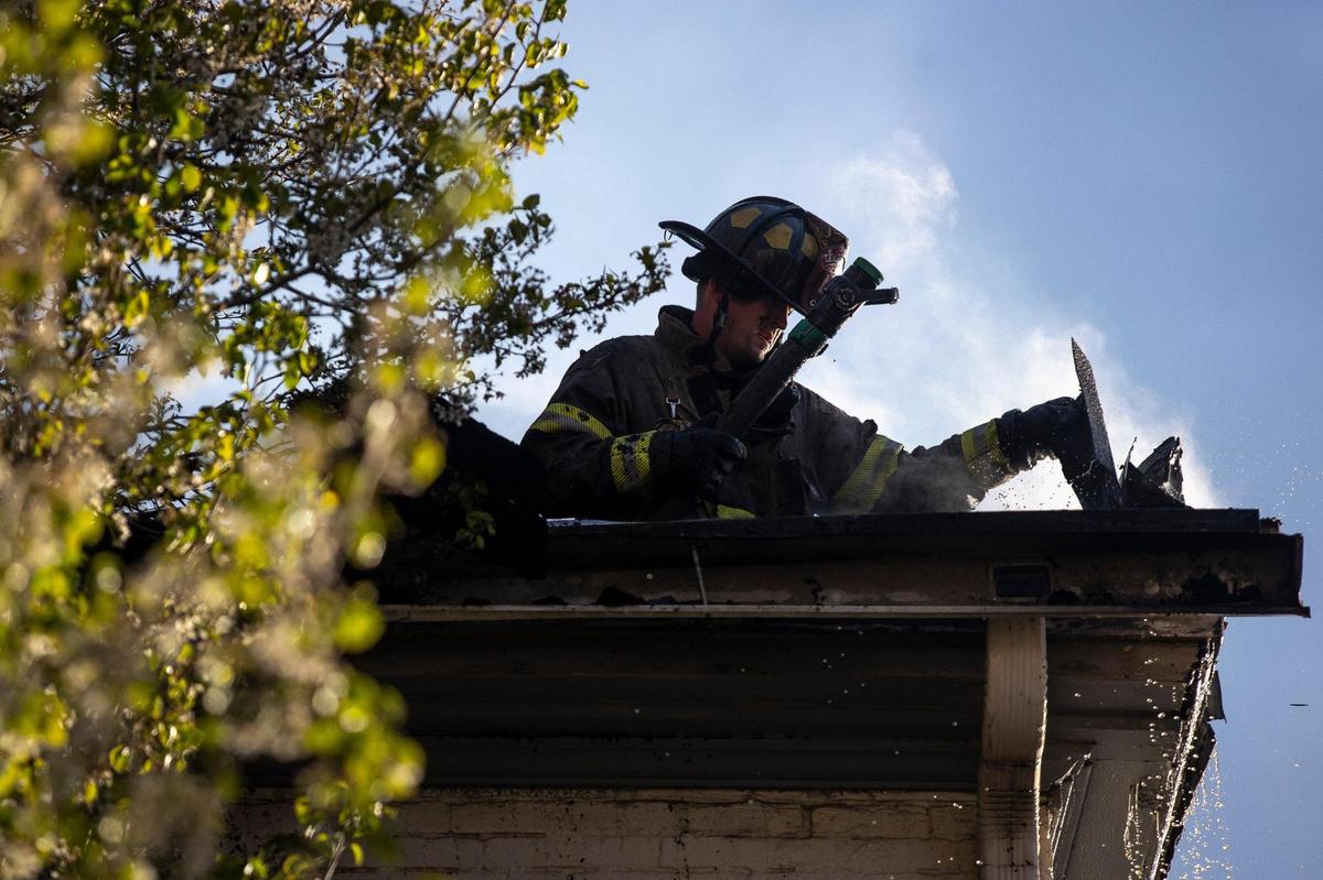 Members of the Lexington Fire Department respond to a structure fire at the corner of North Upper and West Second streets in downtown Lexington, Ky., on Thursday, March 31, 2022.