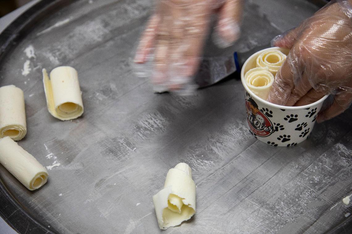 After the ice cream is rolled, it is placed in a cup.