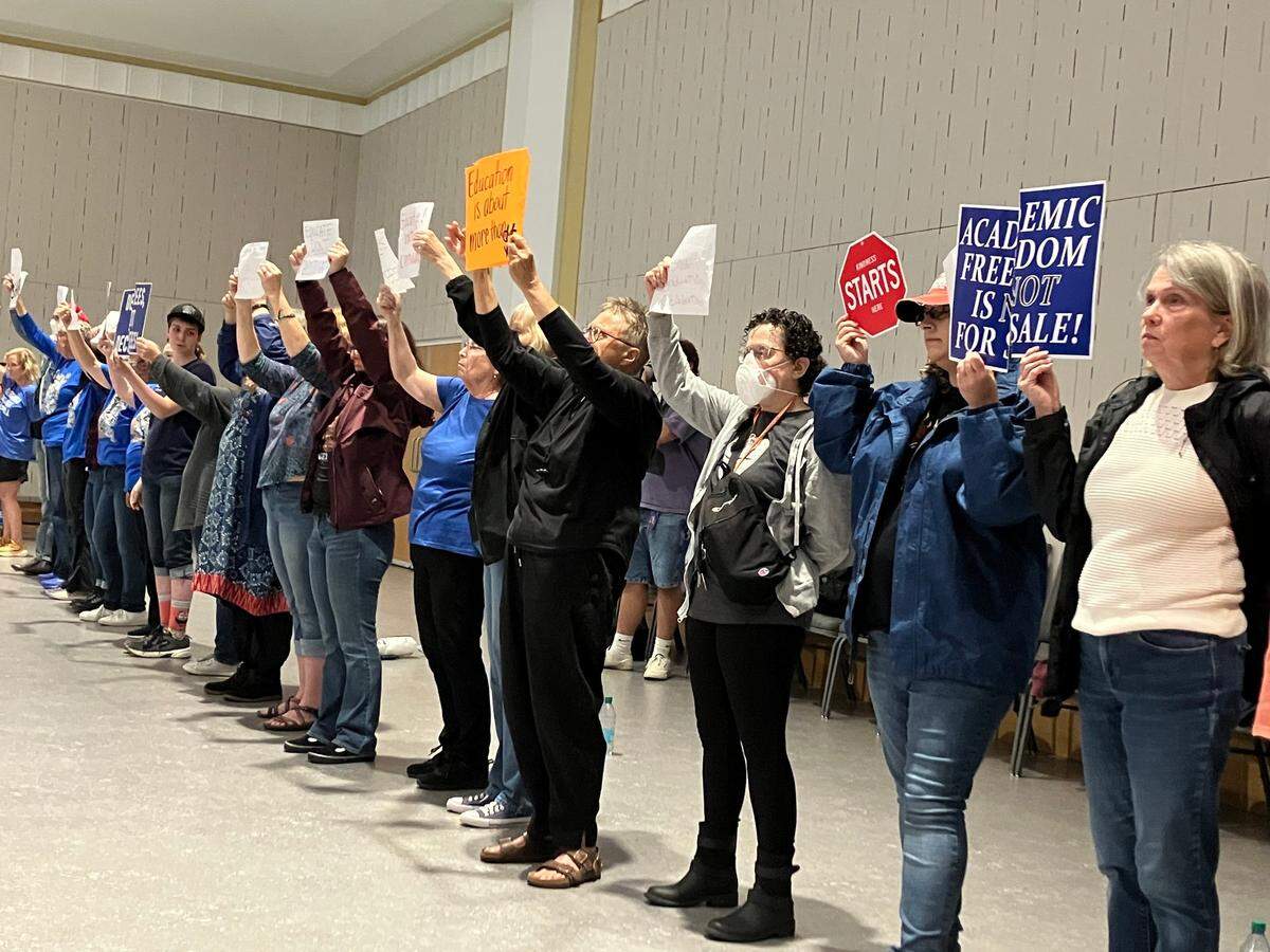 More than 30 protesters stood silently during the University of Kentucky Board of Trustees meeting on Friday, April 25, 2025, at the UK Gatton Student Center in Lexington, Ky.