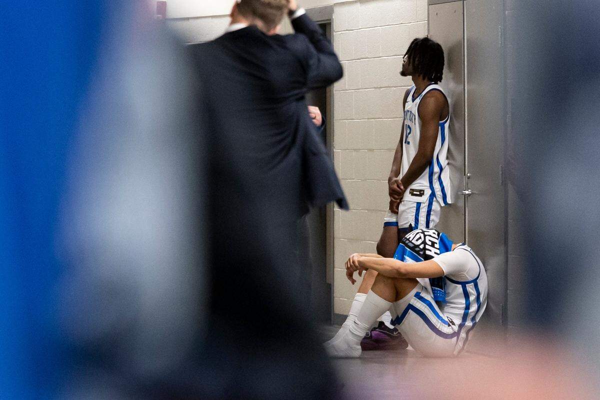 Kentucky forward Tre Mitchell sits next to Antonio Reeves in the hallway outside the Wildcats’ locker room after an 80-76 loss to Oakland in the NCAA Tournament.