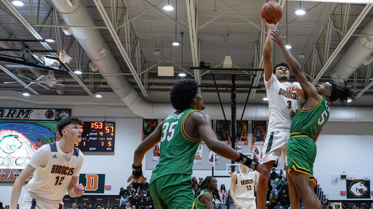 Douglass' DeMarcus Surratt (#3) takes on Bryan Station's Amari Owens (#5) and Taeshawn Adams (#35) for two points towards the final moments of the Bryan Station vs Frederick Douglass boys basketball game at Frederick Douglass High School on Jan. 13, 2026, in Lexington, Ky.