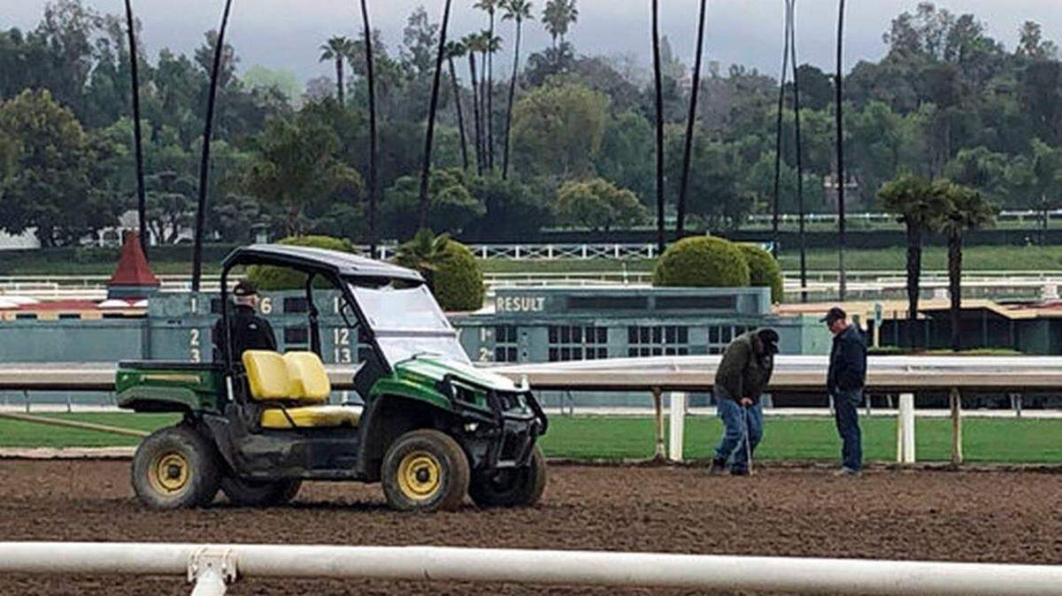 Investigators test the track surface at Santa Anita Park in Santa Anita, Calif. on Thursday March 7, 2019. Santa Anita has canceled horse racing indefinitely to re-examine its dirt surface after the deaths of numerous horses in the last two months.