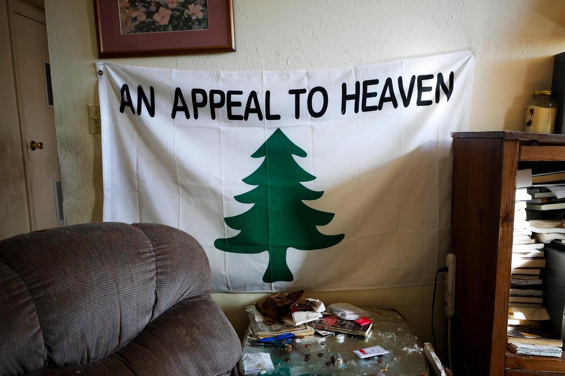 A flag and other belongings sit in the damaged shell of Dawson Village apartments in Dawson Springs, Ky., Monday, Dec. 13, 2021.