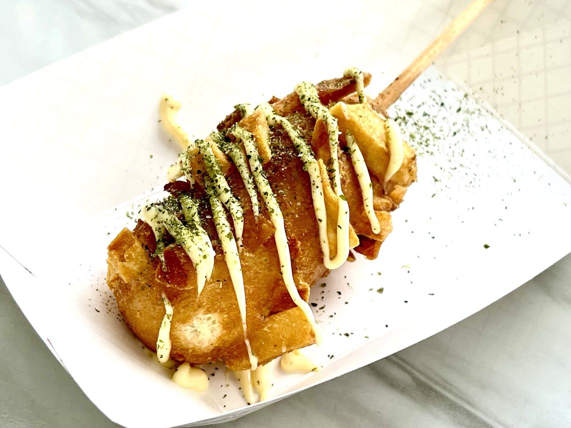 Tsaocha Korean corn dog is made with fish hot dog covered with seaweed flakes and drizzled with Japanese Kewpie mayo.