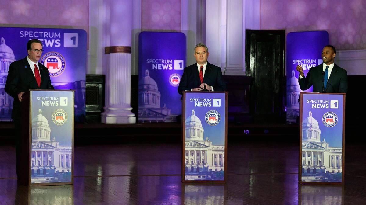 Kentucky Attorney General Daniel Cameron, right, responds to a question from the moderator as Kentucky State Auditor Mike Harmon, left, and Kentucky Agricultural Commissioner Ryan Quarles listen during the Kentucky Gubernatorial GOP Primary Debate in Louisville, Ky., Tuesday, March 7, 2023. (AP Photo/Timothy D. Easley, Pool)