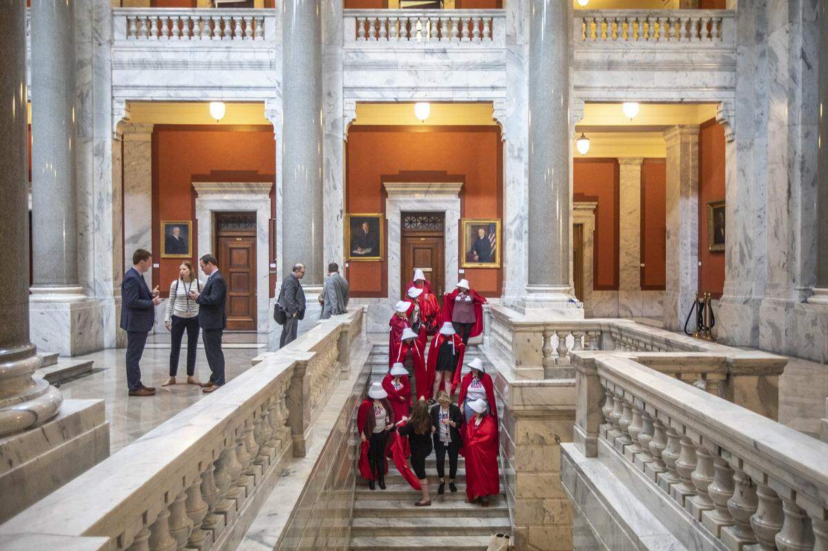 Opponents of two anti-abortion bills in the Kentucky House Judiciary Committee, dressed as characters from the Handmaid’s Tale, prepare to take a photo at the Kentucky state Capitol on Wednesday, March 4, 2020.
