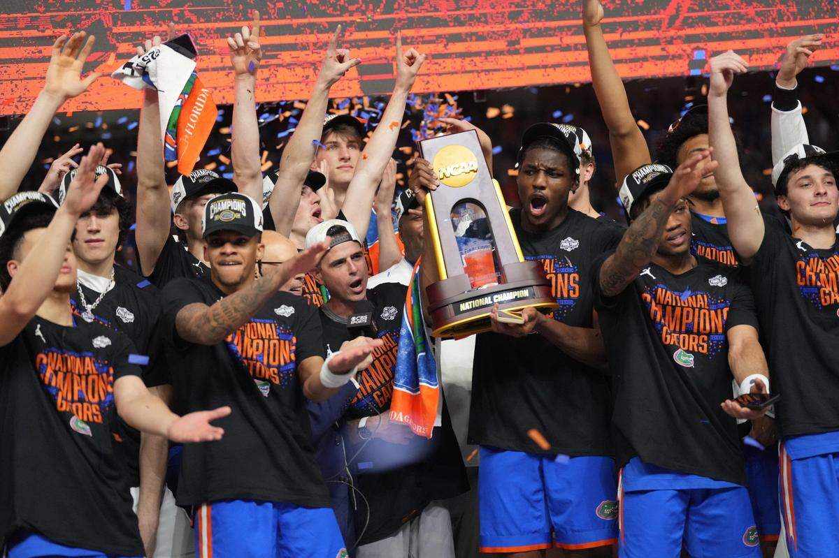 Florida players celebrate with the trophy after defeating Houston in the national championship game at the Alamodome in San Antonio on Monday night.