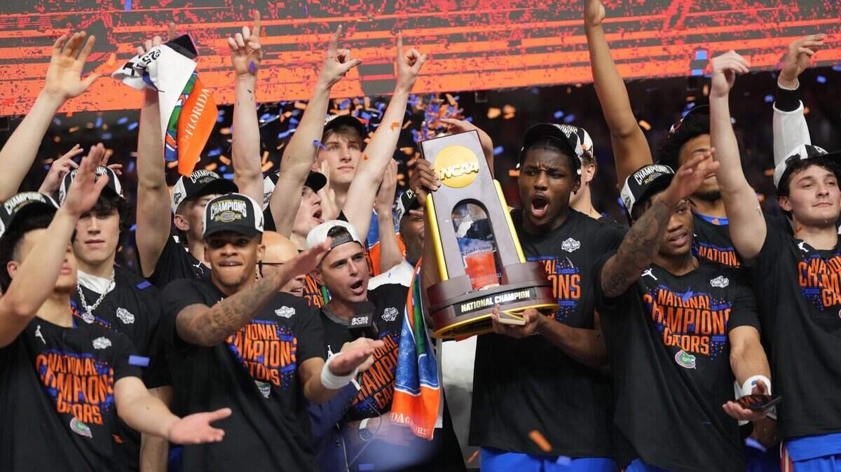 Apr 7, 2025; San Antonio, TX, USA; Florida Gators players celebrate with the trophy after defeating the Houston Cougars in the national championship game of the Final Four of the 2025 NCAA Tournament at the Alamodome. Mandatory Credit: Robert Deutsch-Imagn Images