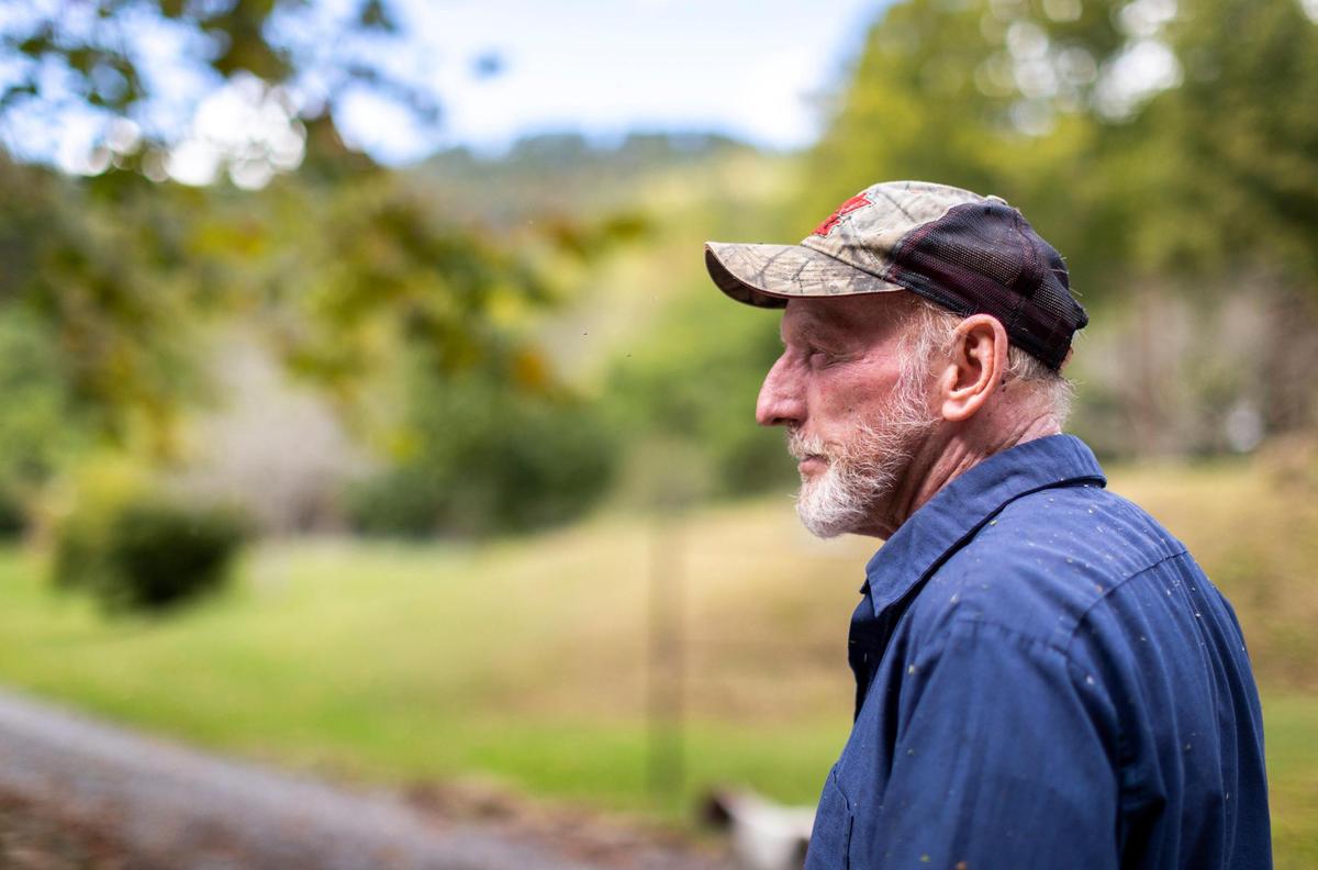 Patchin Tidwell takes a break from doing yardwork around his property in Wallins Creek, Ky., Friday, October 2, 2020. Tidwell lives across a creek that feeds into Wallins Creek. In the past, when it rained heavily, water has built up in abandon mines in the hills behind Tidwell’s property and broken loose destroying bridges that Tidwell and his neighbors use daily.
