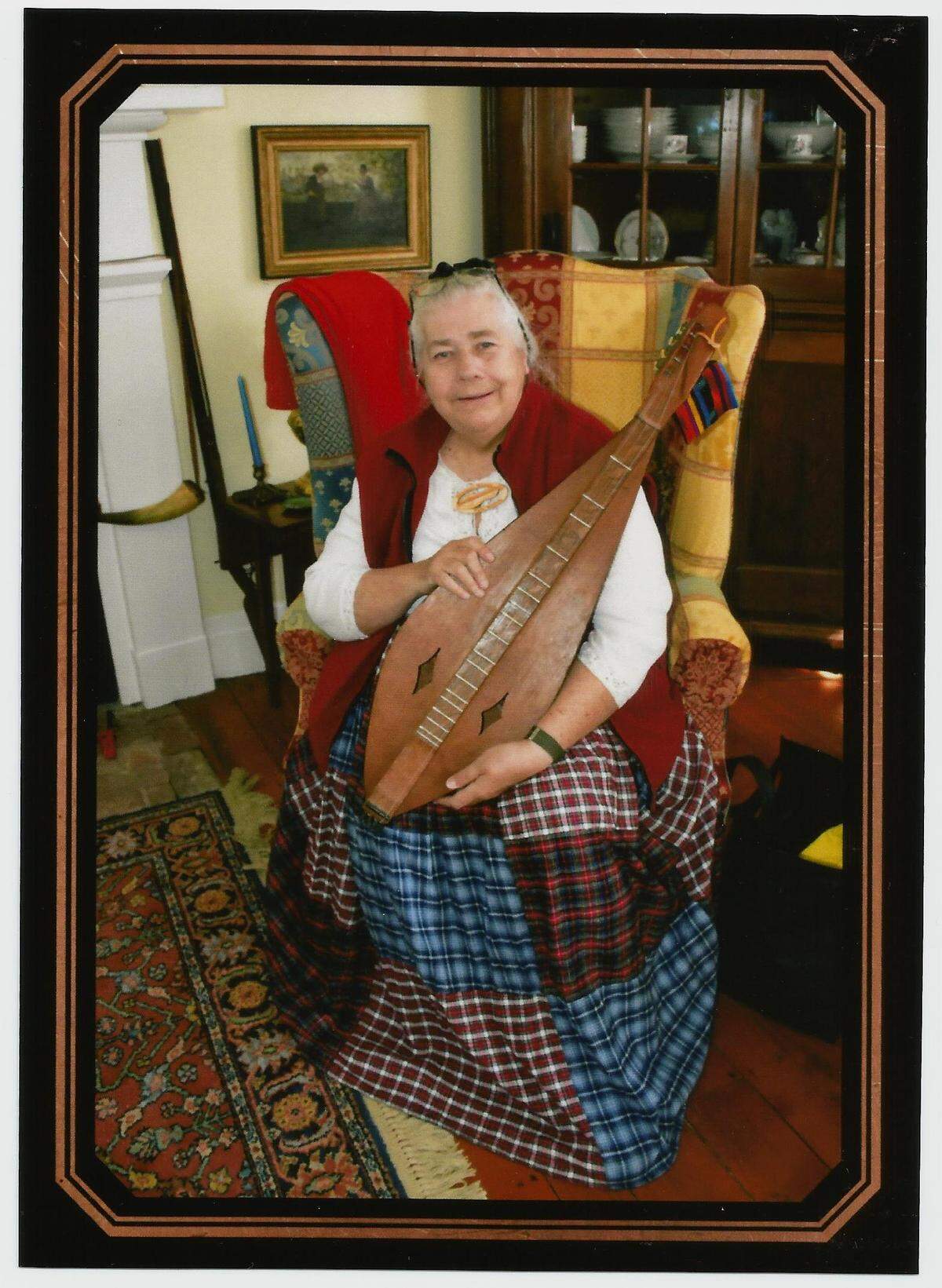 Pat Holland holds the mountain dulcimer that she got a Woodstock in 1969. Her husband, Rob, bartered food for it. They came prepared with a station wagon full of food, a camp stove and a mattress.