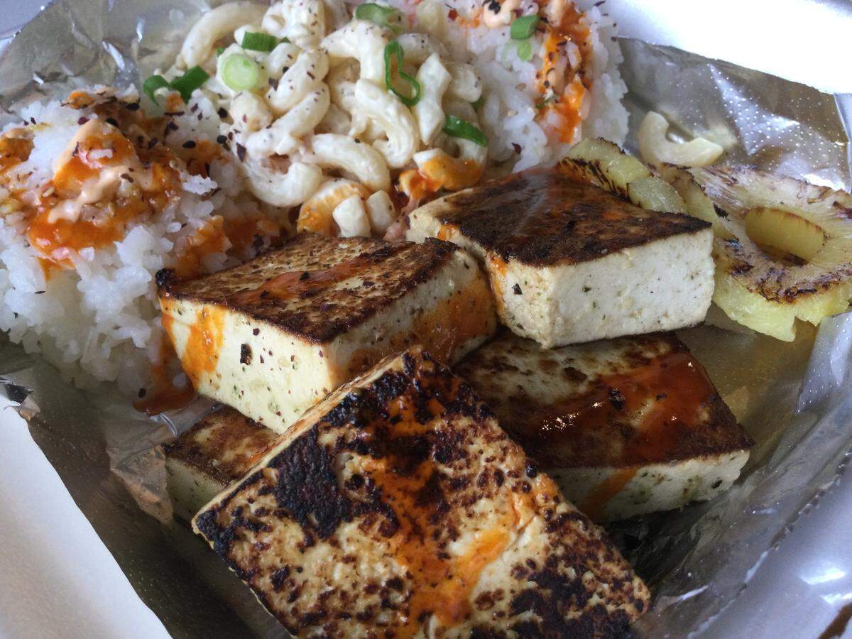 The grilled tofu lunch plate at Big Kahuna Hawaiian BBQ comes with squares of marinated and grilled tofu with charred pineapple over sticky rice with macaroni salad.
