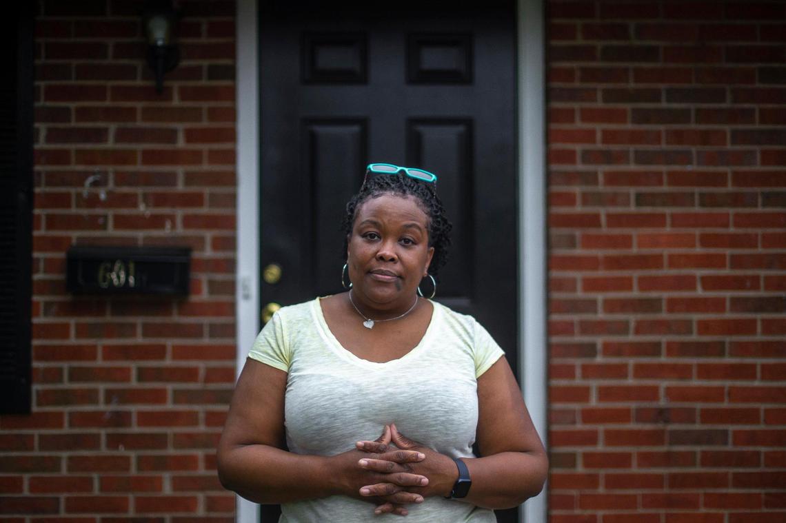 Ilka Tait poses for a portrait outside her rental house in Lexington, Ky., on Tuesday, Sept. 6, 2022. Tait has struggled to get repairs on her rental property completed.