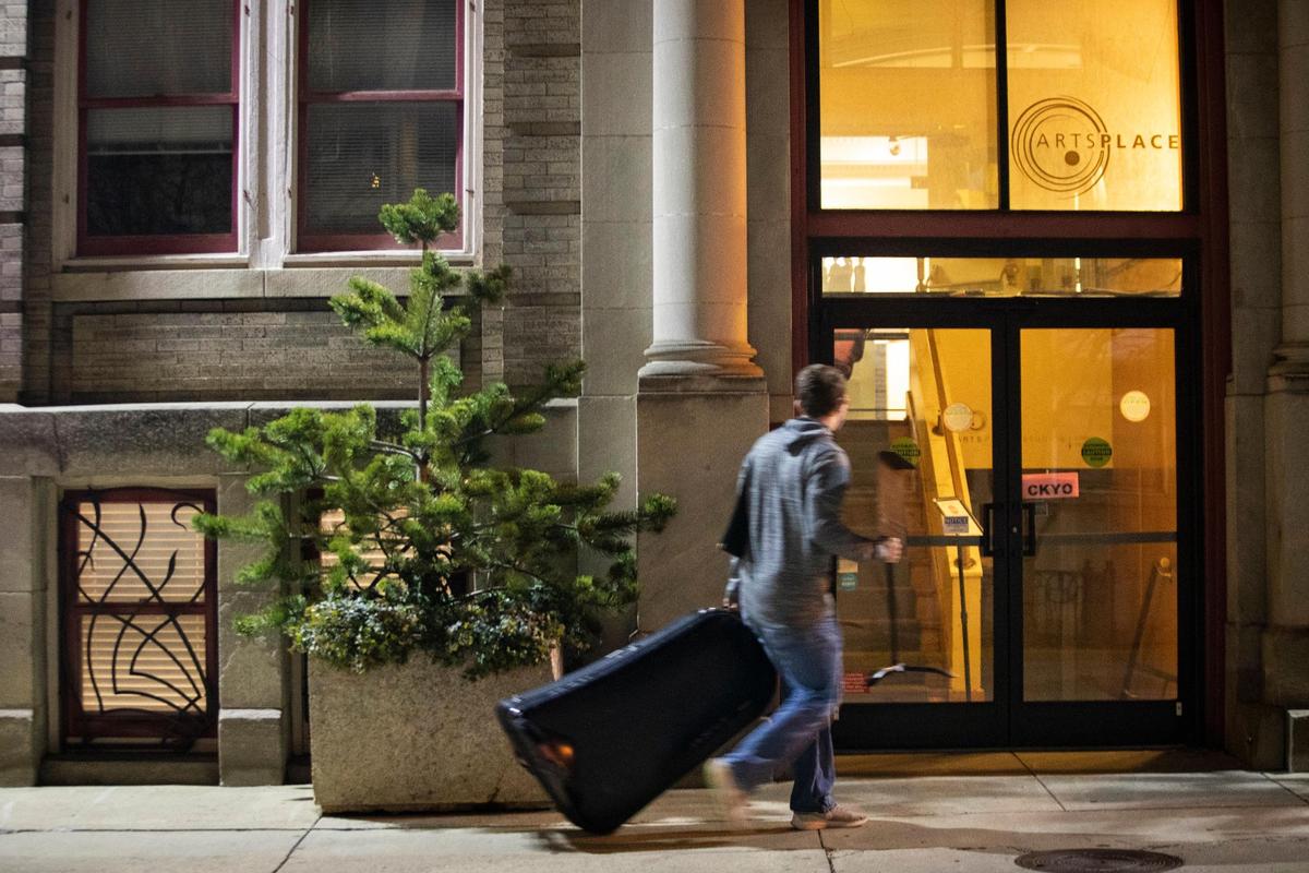 A musician walks to the entrance to ArtsPlace in Lexington, Ky., Tuesday, January 26, 2021. A subcommittee of the Lexington-Fayette Urban County Council has recommended the city sell ArtsPlace and two other buildings to generate money. ArtsPlace is currently the home of LexArts.
