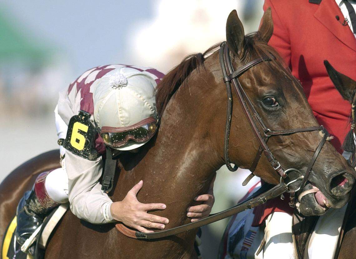 Jockey Jose Santos leaned down to kiss Funny Cide after riding the horse to victory in the 129th running of the Kentucky Derby on May 3, 2003. Funny Cide now lives at the Kentucky Horse Park.
