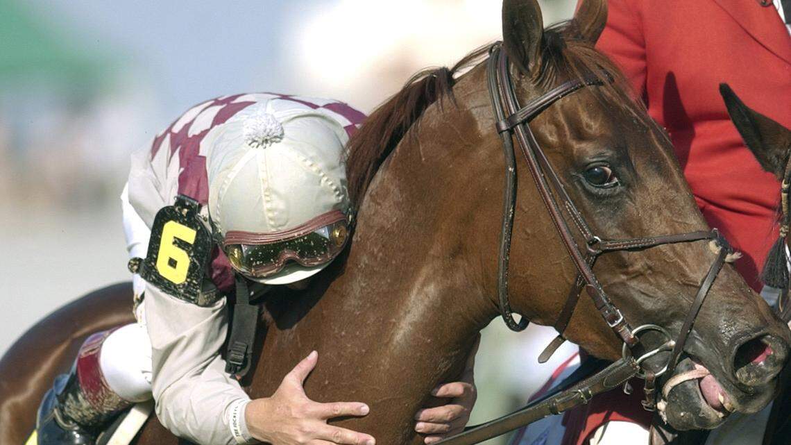 Jockey Jose Santos leaned down to kiss Funny Cide after riding the horse to victory in the 129th running of the Kentucky Derby on 
May 3, 2003. Funny Cide now lives at the Kentucky Horse Park.