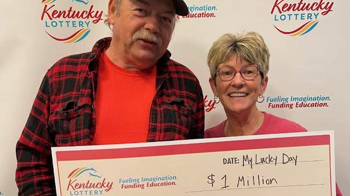 Michael and Sheila Allen pose with a $1 million big check after winning recently playing a Kentucky Lottery scratch-off game.