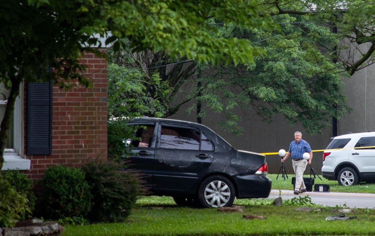 Fayette County Coroner Gary Ginn worked at the scene of a fatal accident early Thursday at the corner of Russell Cave Road and Kees Road in Lexington.