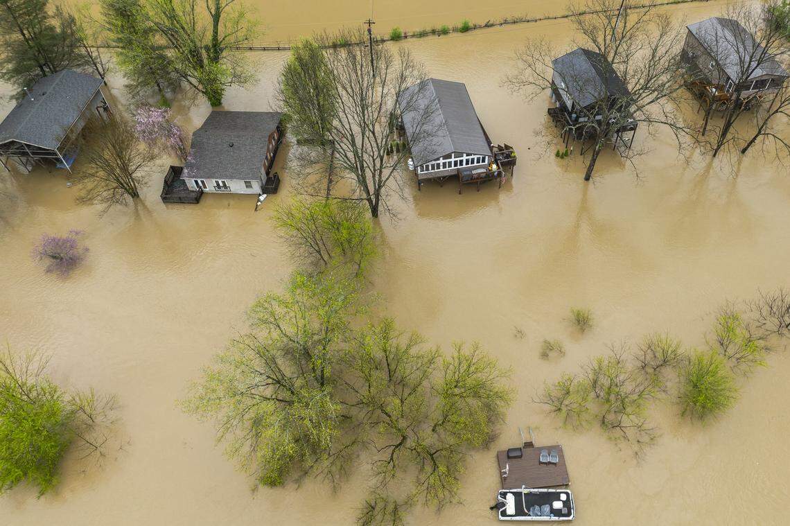 The Kentucky River surrounds homes on Dix Drive near High Bridge in Jessamine County on Saturday, April 5, 2025.