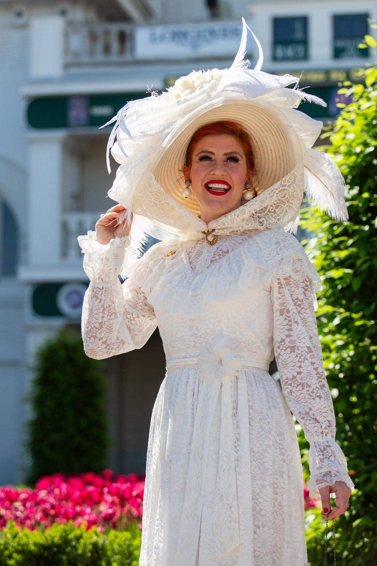 Carrie Ketterman of Louisville, Ky., poses as her husband Jeff takes her photo in the paddock area at Churchill Downs in Louisville, Ky., during the 147th Kentucky Derby on Saturday, May 1, 2021.